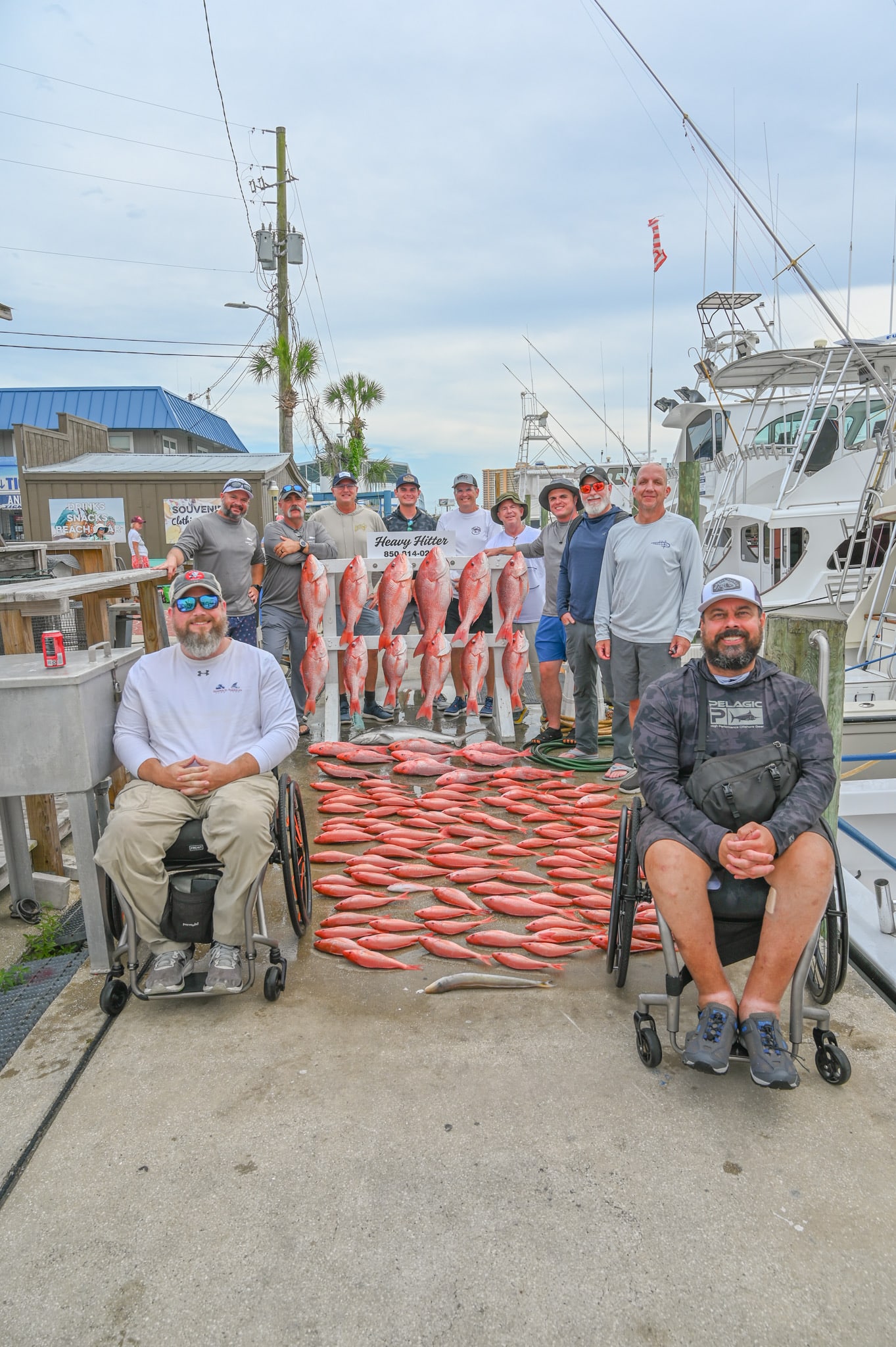 group of fisherman with large haul of fish they caught on Heavy Hitter Charters deep sea fishing boat in PCB